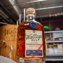 Load image into Gallery viewer, Bottle of Walleye Run Bourbon Whiskey in a brewery setting