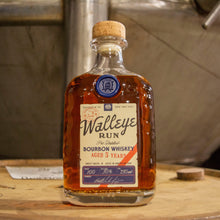 Load image into Gallery viewer, Bottle of Walleye Rum on a wooden barrel with a metallic background