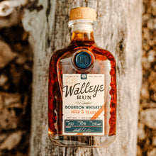 Load image into Gallery viewer, Bottle of Walleye Run bourbon whiskey against a wooden background