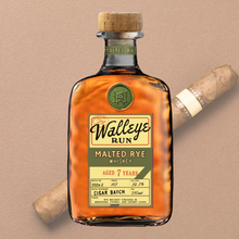 Load image into Gallery viewer, Bottle of Walleye Run Malted Rye Whiskey with a cigar on a beige background