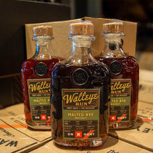 Load image into Gallery viewer, Three bottles of Walleye Run Malted Rye Whiskey on a cardboard surface.