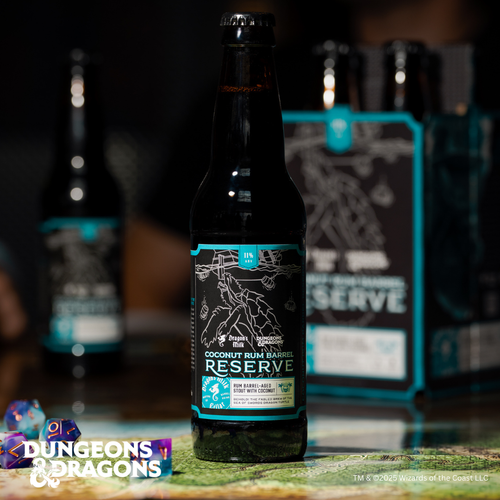 Bottle of coconut rum barrel reserve with a blurred Dungeons & Dragons box in the background