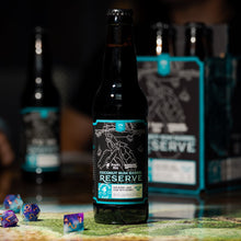 Load image into Gallery viewer, The is a photo of a bottle of Dragon&#39;s Milk x D&amp;D Coconut Barrel Reserve with some dice in front of them.
