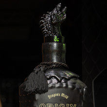 Load image into Gallery viewer, Bottle of 'Dragons Milk' Mead Cask with 'Dungeons &amp; Dragons' branding on a dark background.
