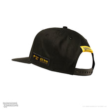 Load image into Gallery viewer, Black Dungeons &amp; Dragons snapback hat shown from the back, featuring Dragon’s Milk d20 Brew Brass Dragon Edition branding and a yellow Dungeons &amp; Dragons tag.
