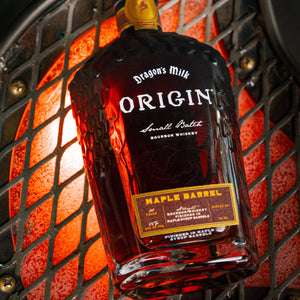 This is a bottle of Dragon's Milk Origin Maple Barrel as a flat lay